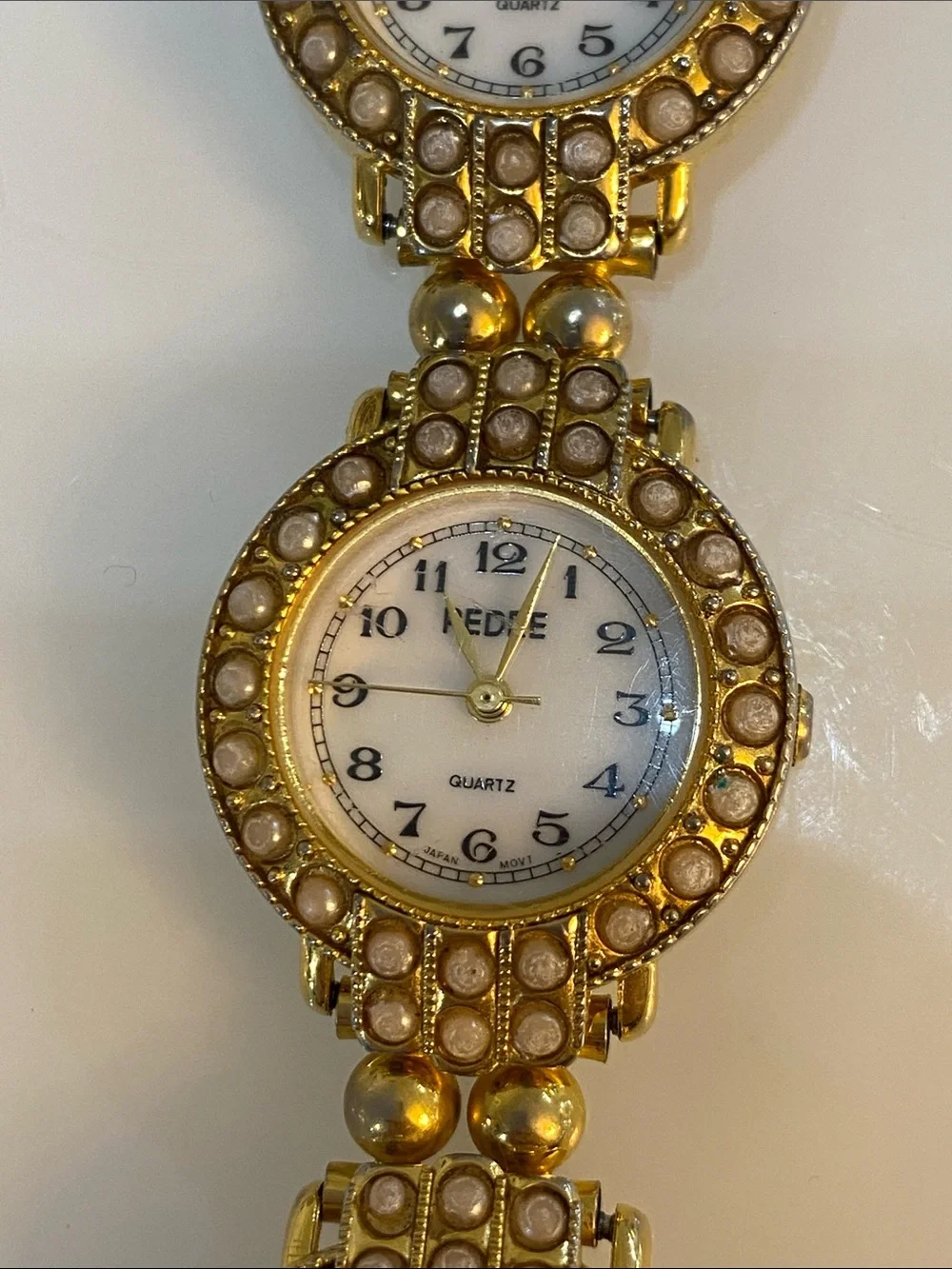 Faux pearl gold tone watch